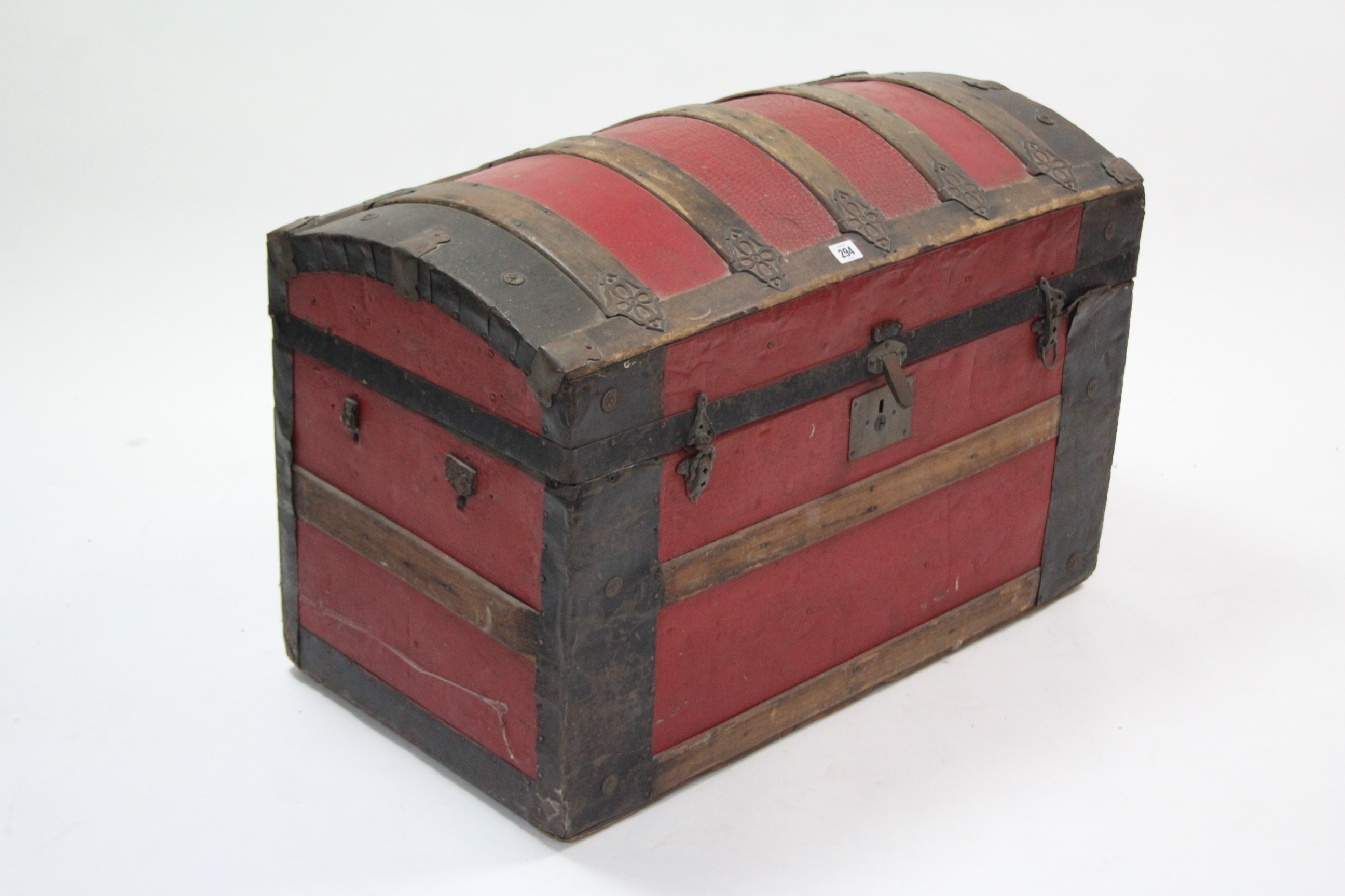 An iron-bound & red-finish deal dome-top travelling trunk (lacking side handles), 32¾” wide.