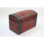 An iron-bound & red-finish deal dome-top travelling trunk (lacking side handles), 32¾” wide.
