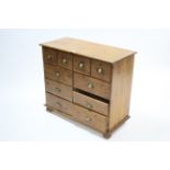 A matching pine chest, fitted with an arrangement of 10 small drawers, 36" wide.