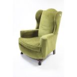 A late 19th/early 20th century wing-back armchair upholstered pale green velour, & on short cabriole