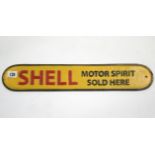 A reproduction painted cast-iron sign "SHELL MOTOR SPIRIT SOLD HERE", 19¼" x 3½".