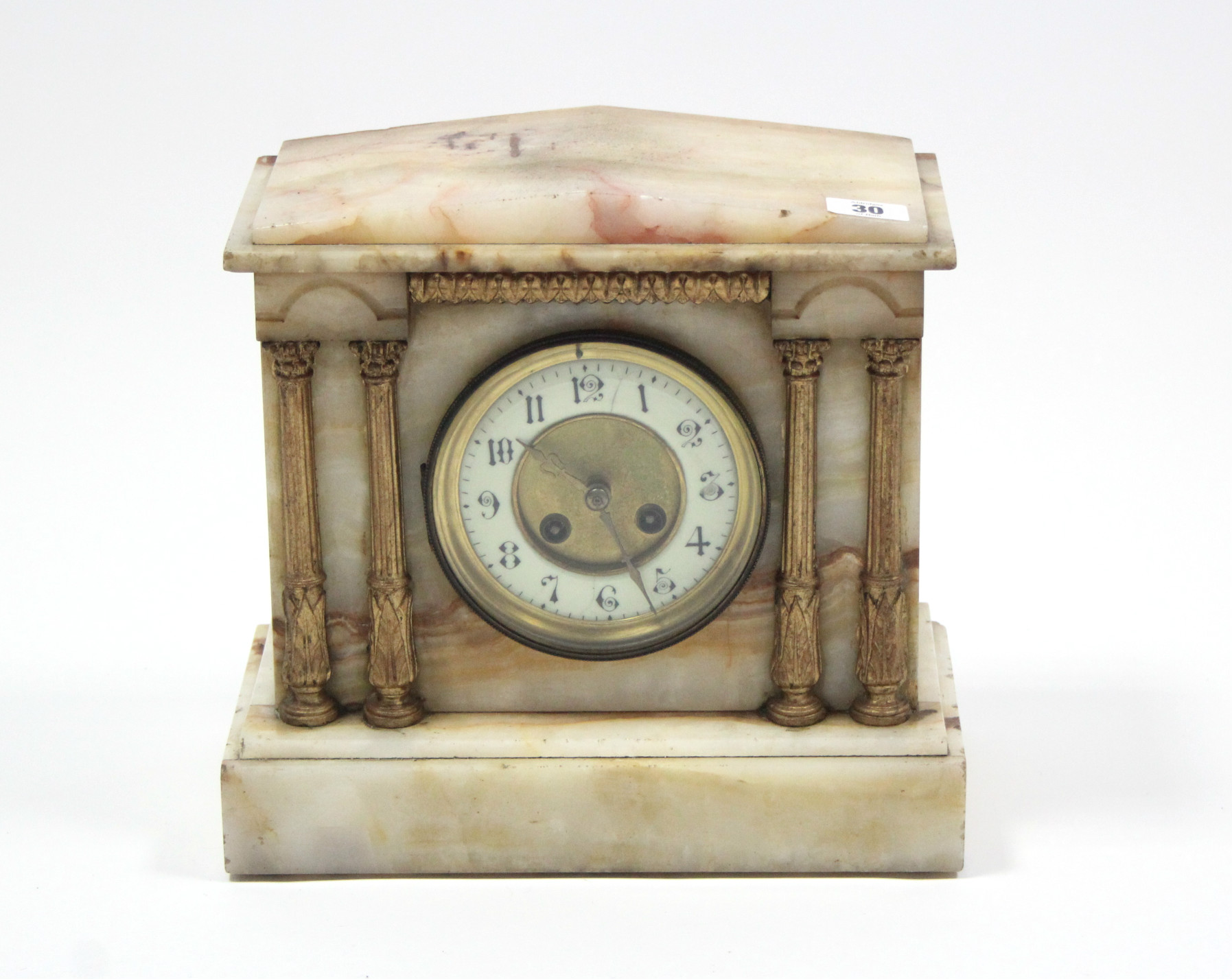 A Victorian mantel clock with two-part dial, striking movement, and in cream onyx architectural