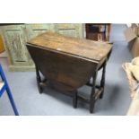 A 19th century oak oval gate-leg dining table on baluster-turned legs & turned feet with plain