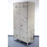 A mid-20th century white painted art-metal industrial locker, fitted two shelves enclosed by pair of