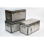 Three silvered-metal finish travelling trunks, all 36” wide, one w.a.f.