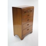 An oak-finish upright chest fitted five long graduated drawers, & on shaped plinth base, 26½" wide x