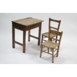 A mid-20th century child’s school desk with hinged lift-lid, & on square legs with plain stretchers,
