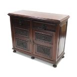 A late Victorian carved walnut sideboard fitted two frieze drawers above cupboard enclosed by pair