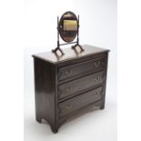 A mid-20th century low oak chest fitted three long graduated drawers with brass swan-neck handles,