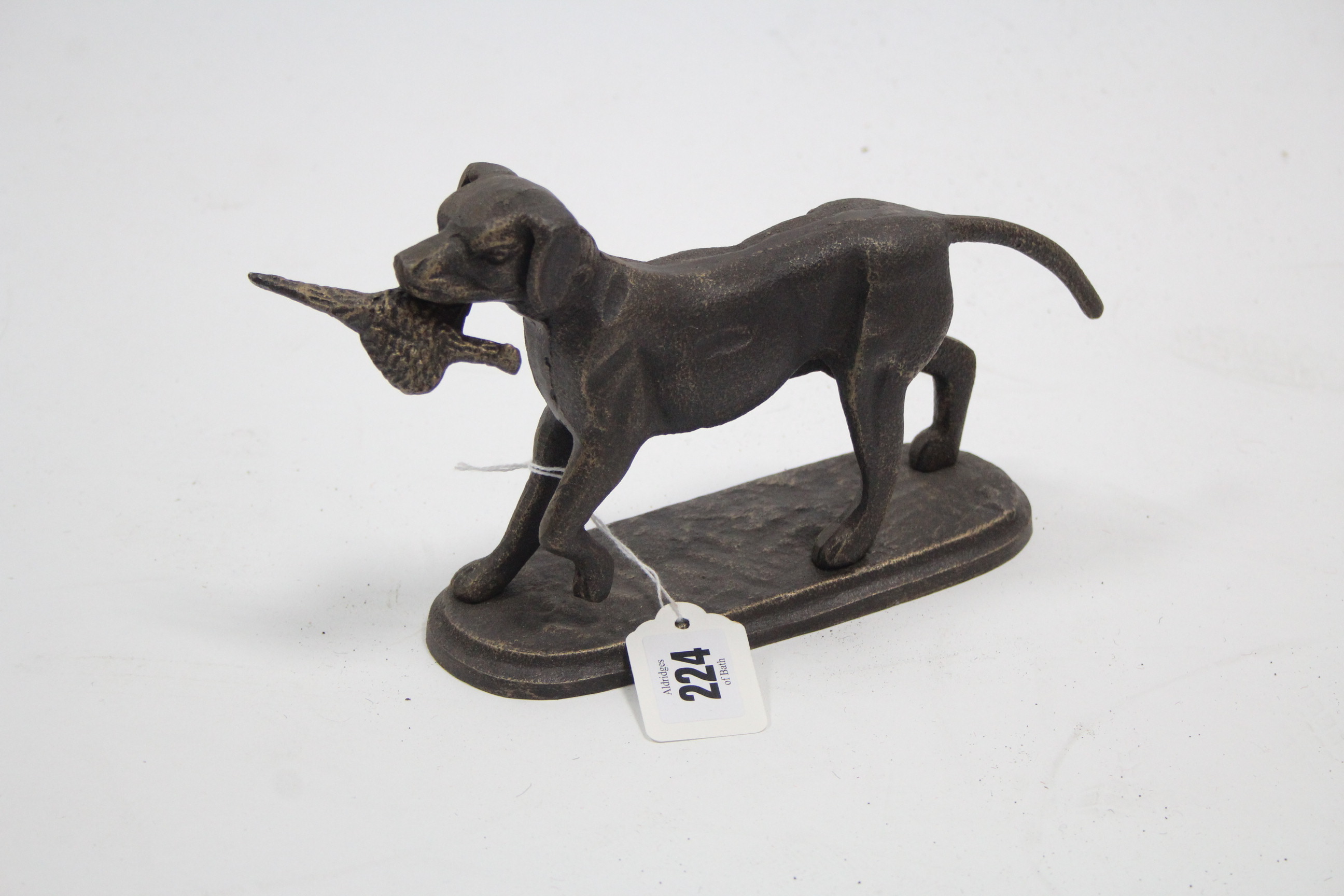 A modern cast-iron ornament in the form of a standing retriever with bird in its mouth, 5¼" high.