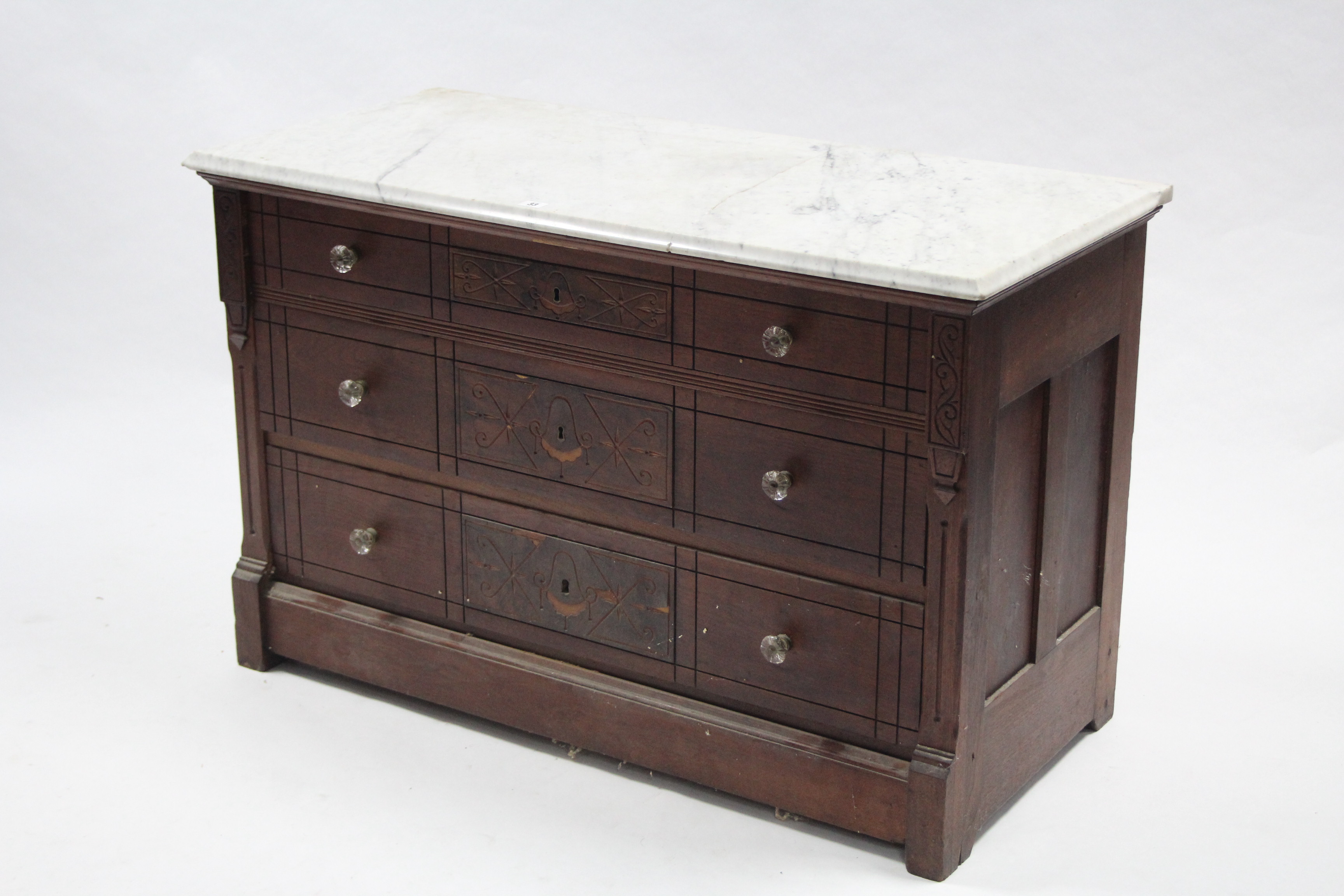 A continental-style carved wooden marble-top low chest fitted three long graduated drawers with