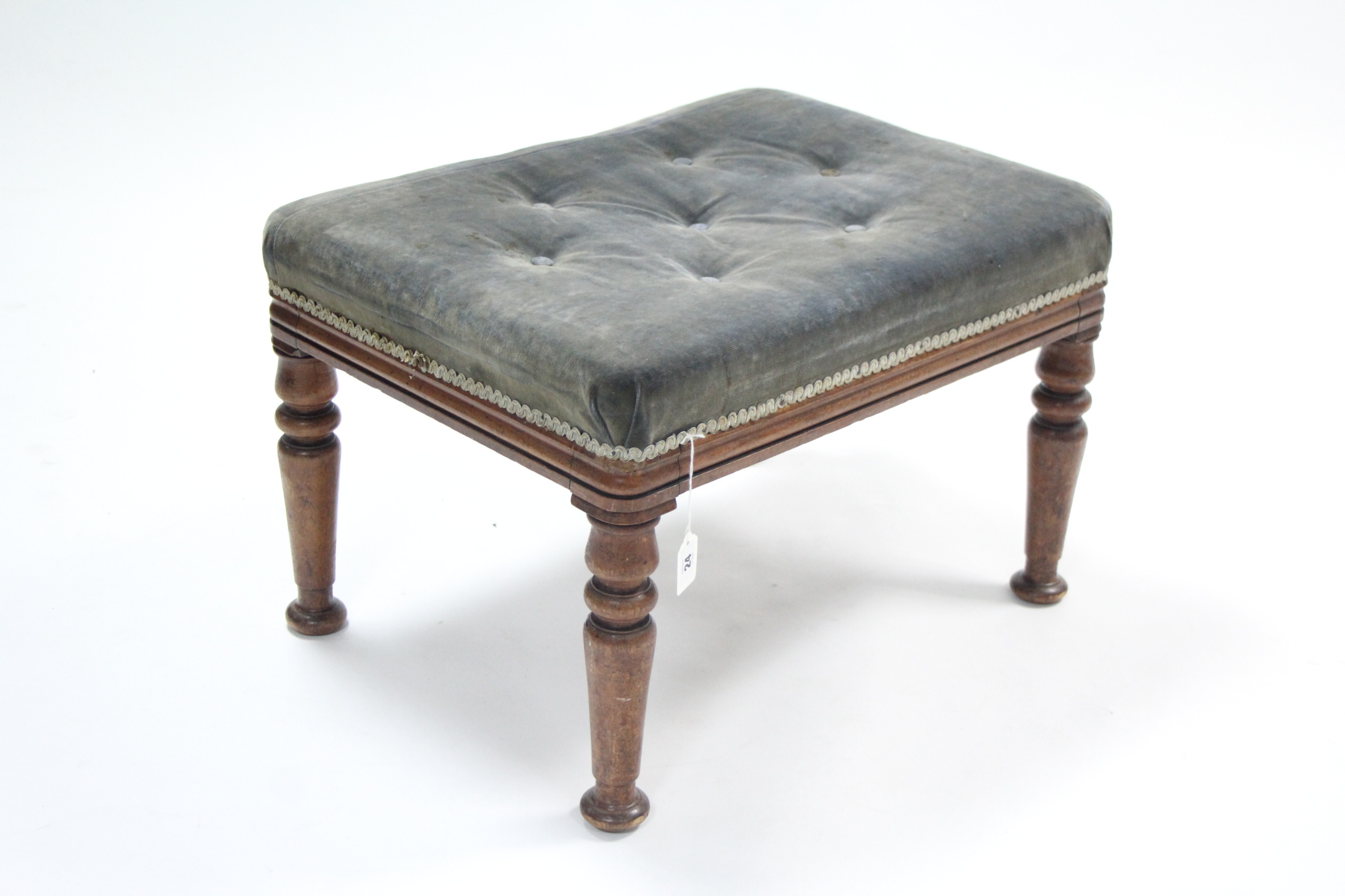 A Victorian walnut stool upholstered pale blue buttoned velour, & on turned tapered legs, 24" wide.