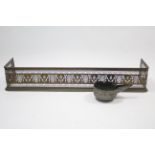 A 19th century brass fender with pierced frieze, 49” long, & an eastern engraved silvered-metal