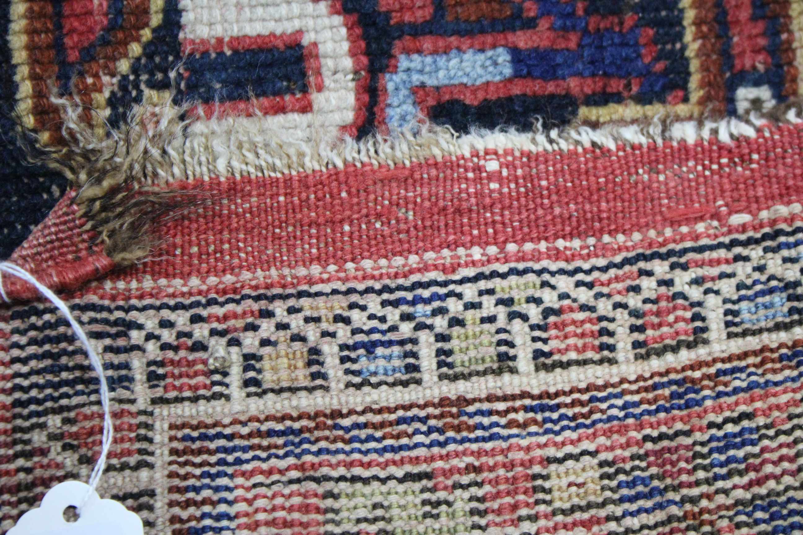 A Persian pattern rug of crimson & ivory ground & with all-over repeating multi-coloured geometric - Image 2 of 4