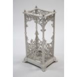 A Victorian-style white painted cast-iron umbrella stand with pierced scroll design to each side,
