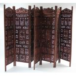 A pair of eastern carved teak four-fold draught screens, 72” high.