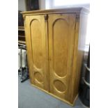 A continental-style pine wardrobe enclosed by pair of panel doors, & on plinth base, 47" wide x 66½"