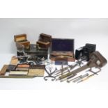 A stereoscope hand-held card viewer; various drawing instruments; a pair of Tronic field glasses,