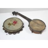 A banjolele (lacking strings), 21" long; & a tambourine with painted floral decoration.