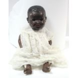 A Japanese black bisque head baby doll (500/8K) with brown sleeping eyes, open mouth, &