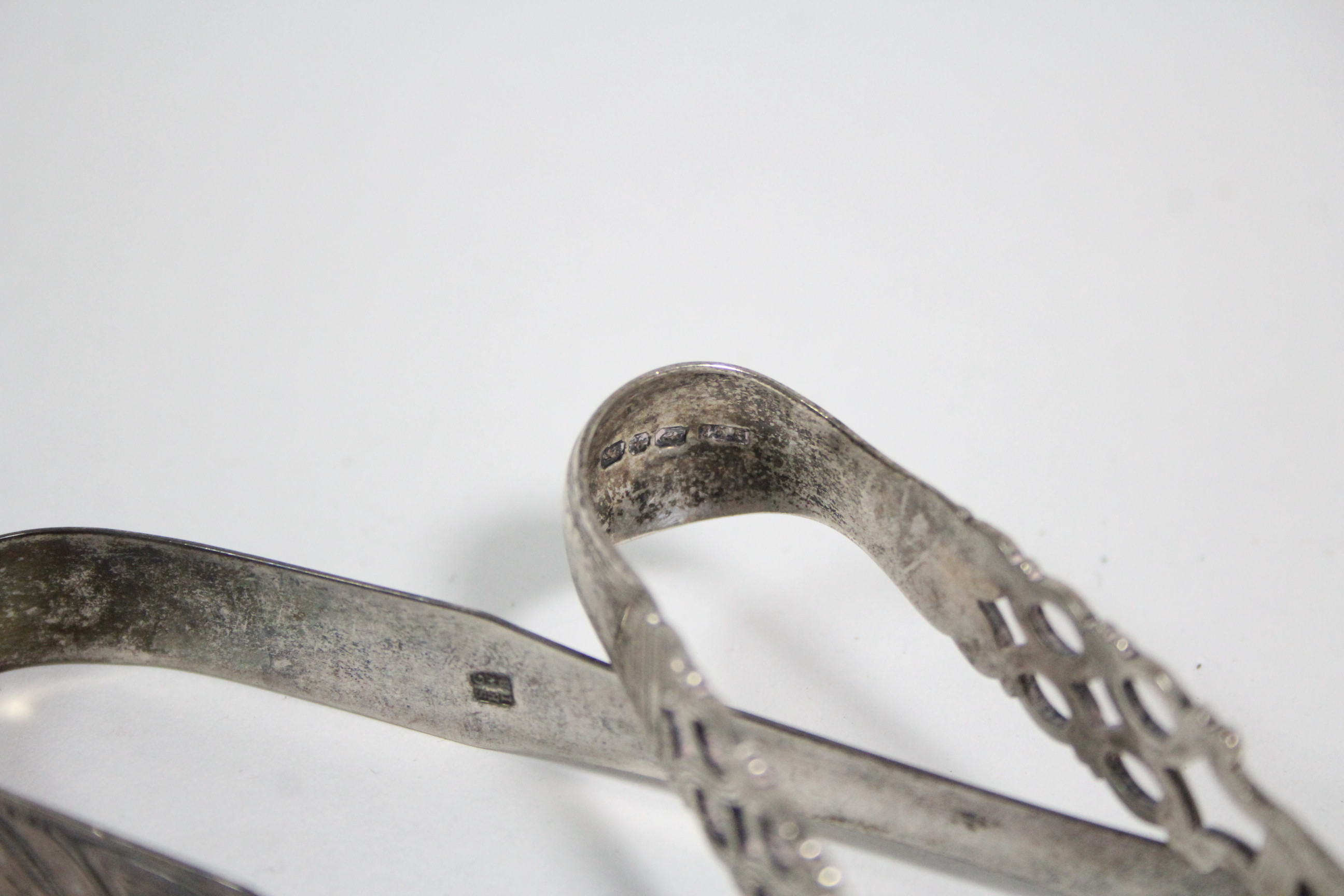 A pair of Victorian sugar tongs in the mid-18th century style, with pierced stems & shell bowls, - Image 2 of 2