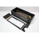 A late 19th century music box with 11" long brass cylinder, & in ebonised wooden case, lacking