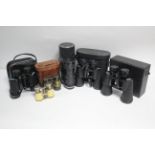 A Vivitar zoom lens; three pairs of binoculars; a pair of field glasses; & a pair of opera glasses.