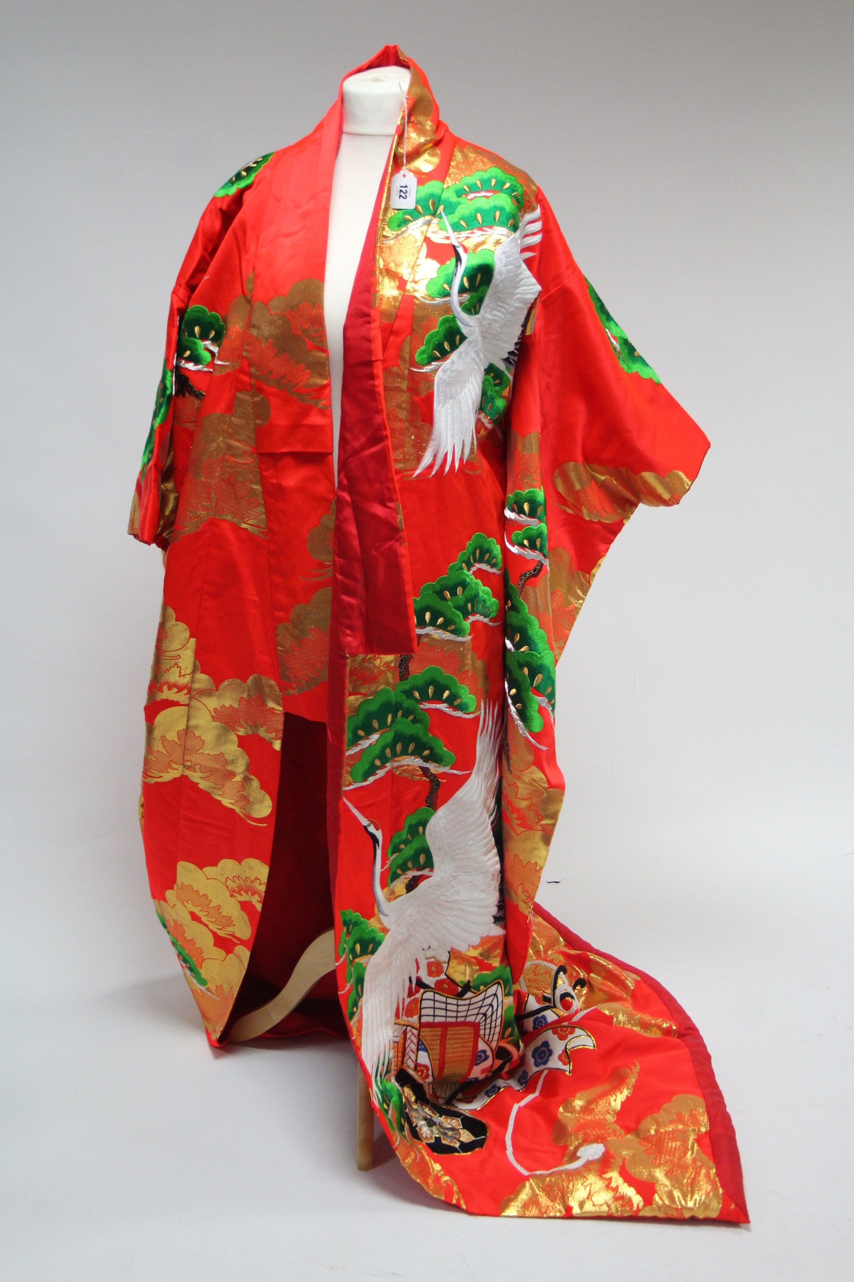 A modern Chinese satin housecoat of red ground & with all-over multicoloured silk embroidered floral