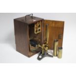 An early 20th century brass monocular microscope b F Davidson & Co. of London, in fitted oak case.