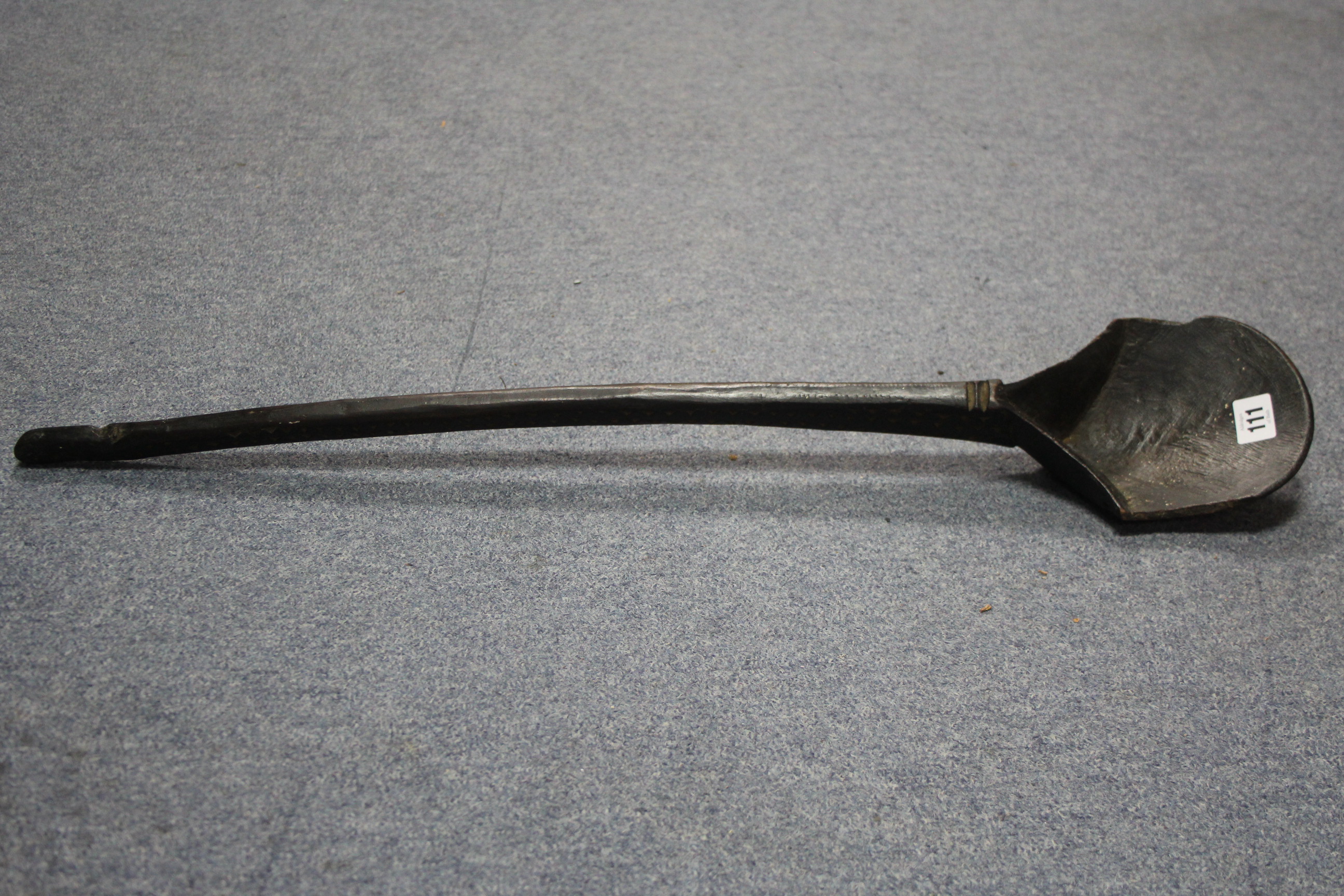 An African carved wood long-handled ladle with shaped bowl; 30" long.