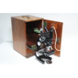 A Cooke, Troughton & Simms of York black lacquered binocular microscope, in fitted mahogany case.