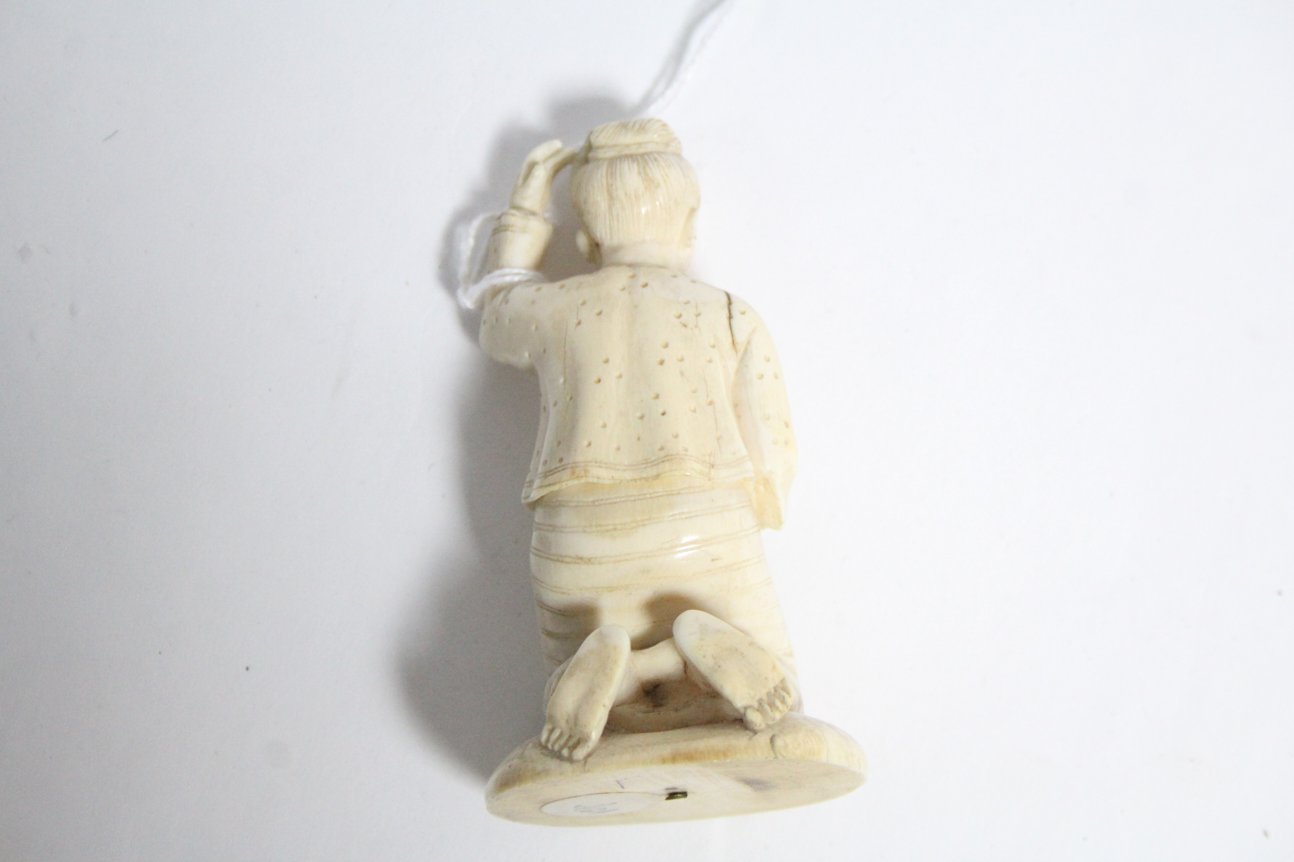 An oriental carved ivory kneeling figure of a woman, 3½” high; a Japanese ivory circular box with - Image 6 of 7