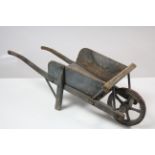 A painted wooden child’s wheelbarrow, 31¾” long, (w.a.f.).