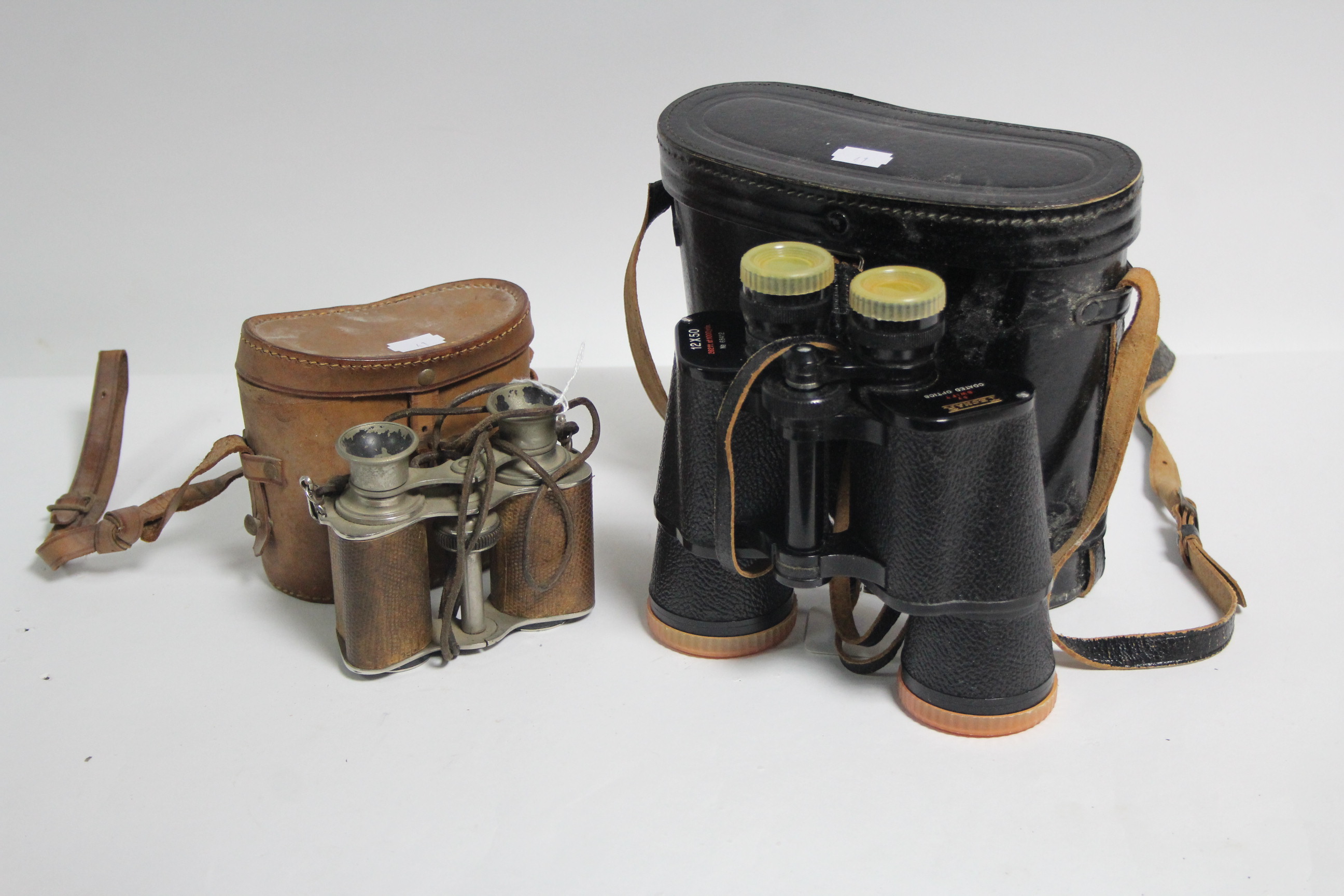 A pair of Swift “Technar” 12 x 50mm binoculars; & a pair of chrome plated field gasses, each with