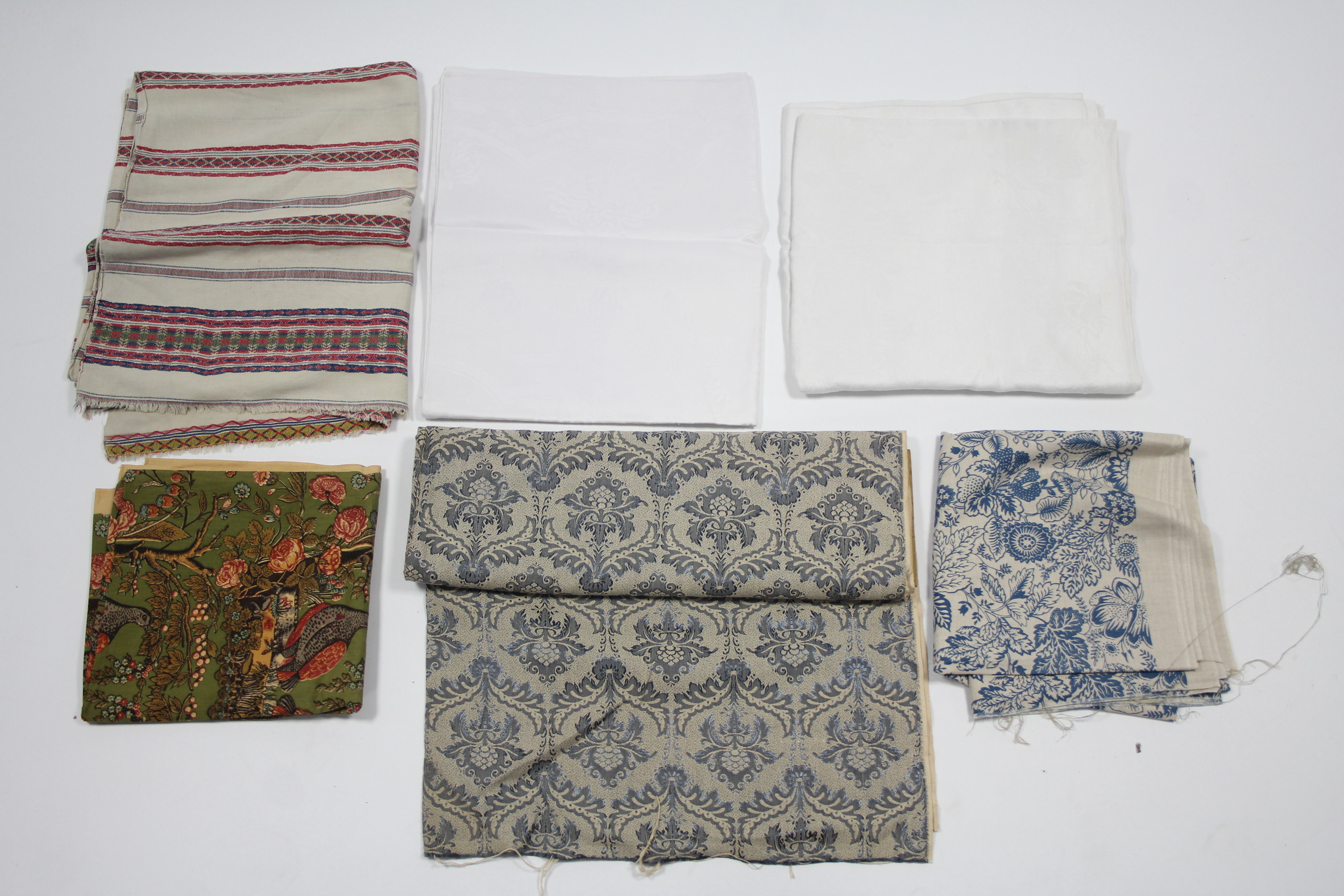 Two white silk damask tablecloths; & various other items of household textiles.