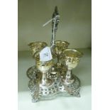 An Edwardian silver plated egg cruet, comprising four pedestal cups and spoons,