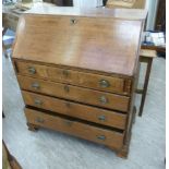 A mid 19thC oak bureau with a fall flap, over four graduated long drawers,