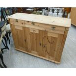 A modern waxed pine sideboard with three in-line drawers and three in-line panelled doors,