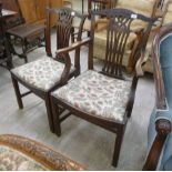 An early 19thC mahogany framed elbow chair, having a carved yoke crest and waisted splat, the open,