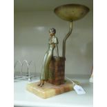 An Art Deco table lamp base, featuring a painted alloy figure,