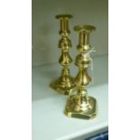 A pair of mid 19thC brass ejector candlesticks with deep sockets and knopped vase stems, on canted,