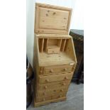 A modern waxed pine bureau, the fall flap over five drawers,