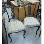 A set of six Edwardian black painted, splat back dining chairs,