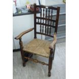 Two similar, late 19thC fruitwood framed Lancashire, triple row, spindle back, open arm chairs,