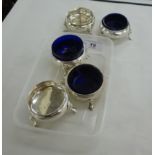 A matched set of five George III silver circular salt cellars (and three blue glass liners) on hoof