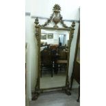 A Regency carved giltwood framed dressing mirror (with a later plate), having an urn crest,