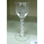 A 19thC wine glass, the ogee shaped bowl with a flared rim and engraved floral ornament,