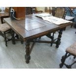 An early 20thC oak draw leaf dining table, the panelled top raised on barleytwist and block legs,