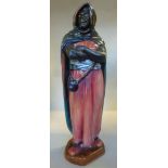 A Royal Doulton china figure 'The Moor' with a red, blue and green cloak and red robe,