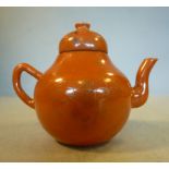 A late 19thC Chinese gilded coral coloured glazed porcelain miniature teapot of bulbous form with a